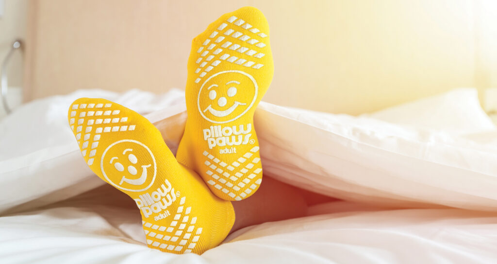 Close up foots of family with color sock on the bed